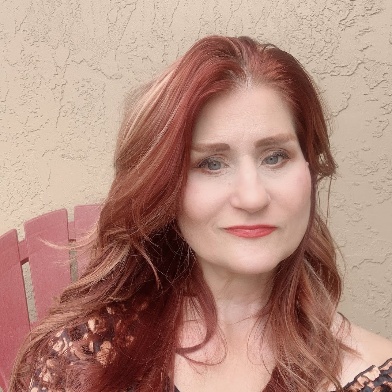 Professional hairstylist finishing a client's luxury waves in a modern, upscale salon environment